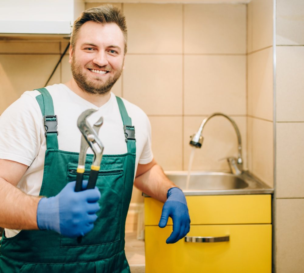 plumber-in-uniform-holds-wrench-handyman.jpg